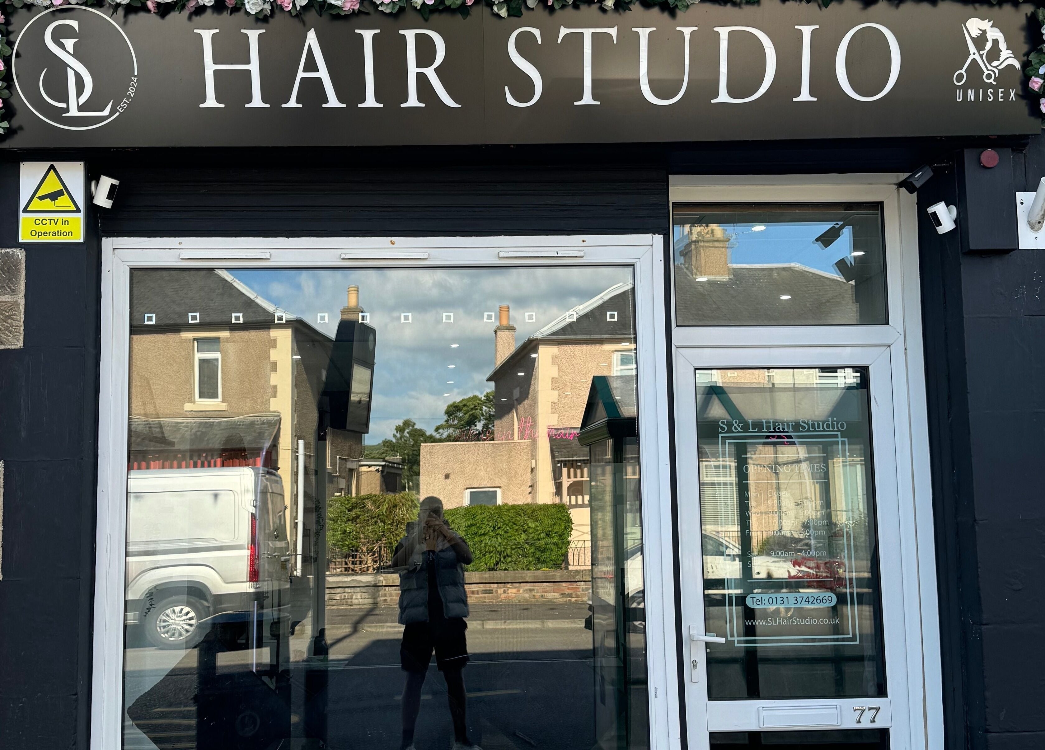Exterior of S & L Hair Studio in Newtongrange, Scotland, GB with floral decorations.