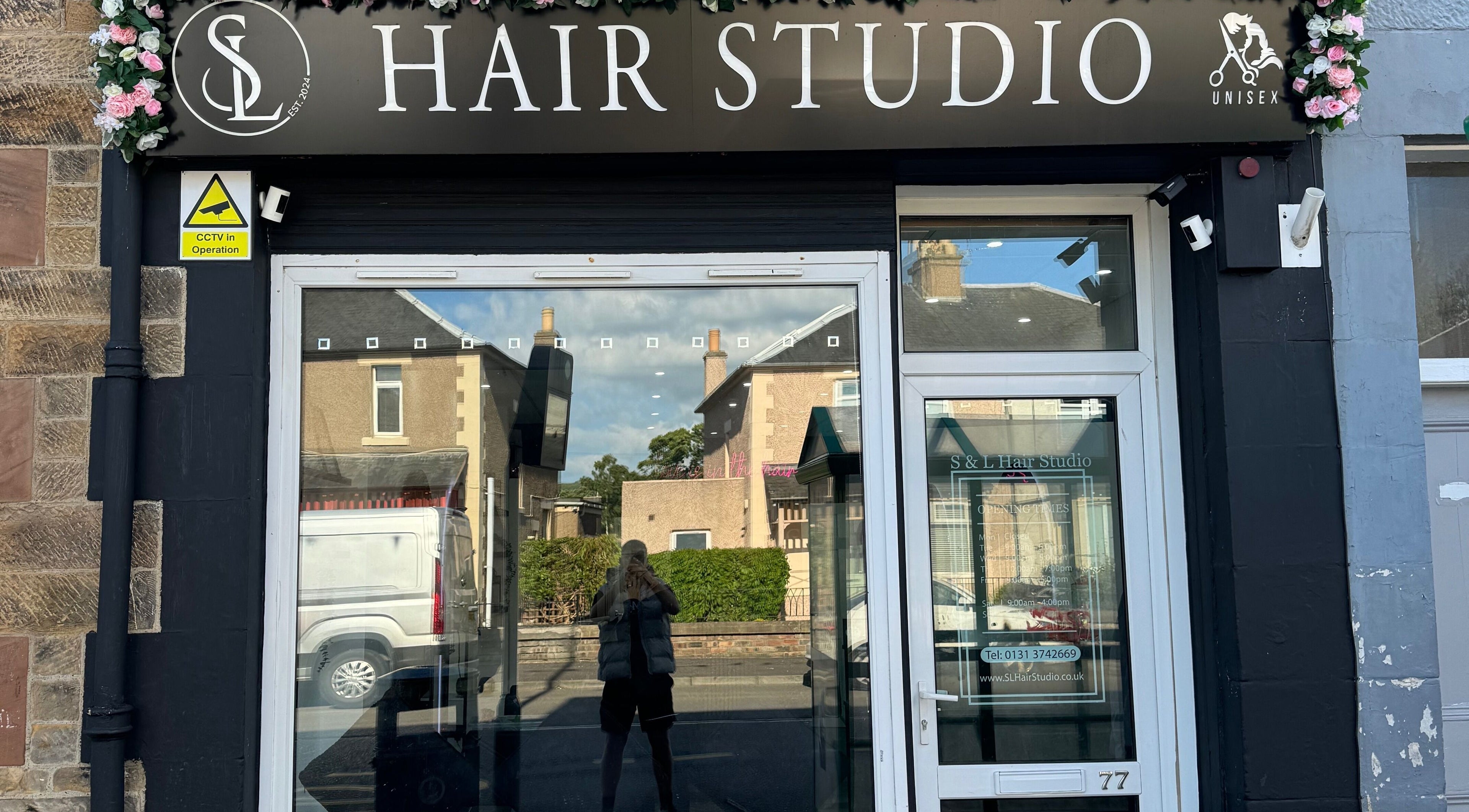 Exterior of S & L Hair Studio in Newtongrange, Scotland, GB with floral decorations.