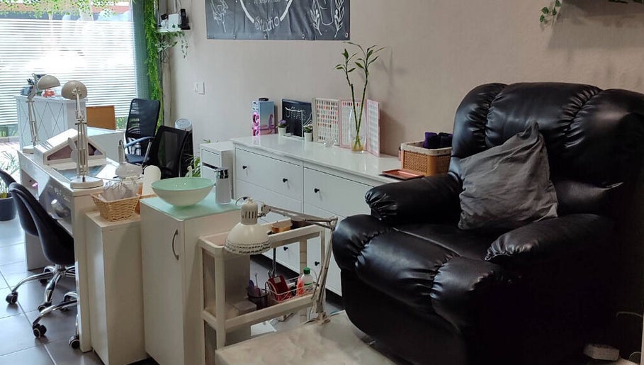 Interior acogedor de Yhara Nails Studio, Madrid, con sillón de masaje y estación de manicura.