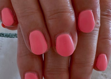 Vibrant coral nails at Sun Kissed Nail & Wax Studio, Thurso, Scotland, GB. Perfect for a chic, polished look.