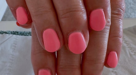 Vibrant coral nails at Sun Kissed Nail & Wax Studio, Thurso, Scotland, GB. Perfect for a chic, polished look.