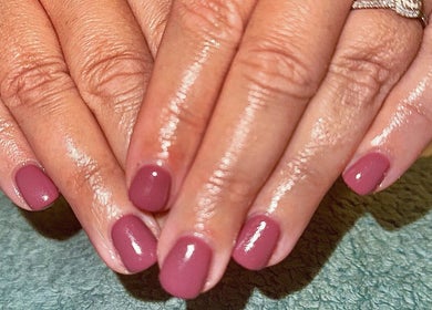 Elegant pink manicure at Sun Kissed Nail & Wax Studio, Thurso, Scotland, GB. Perfectly polished nails on display.