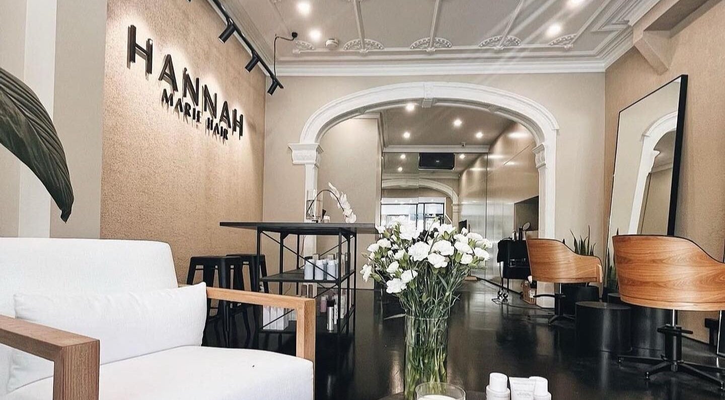 Chic interior of The Blowdry Parlour in Woollahra, New South Wales with stylish seating and floral decor.
