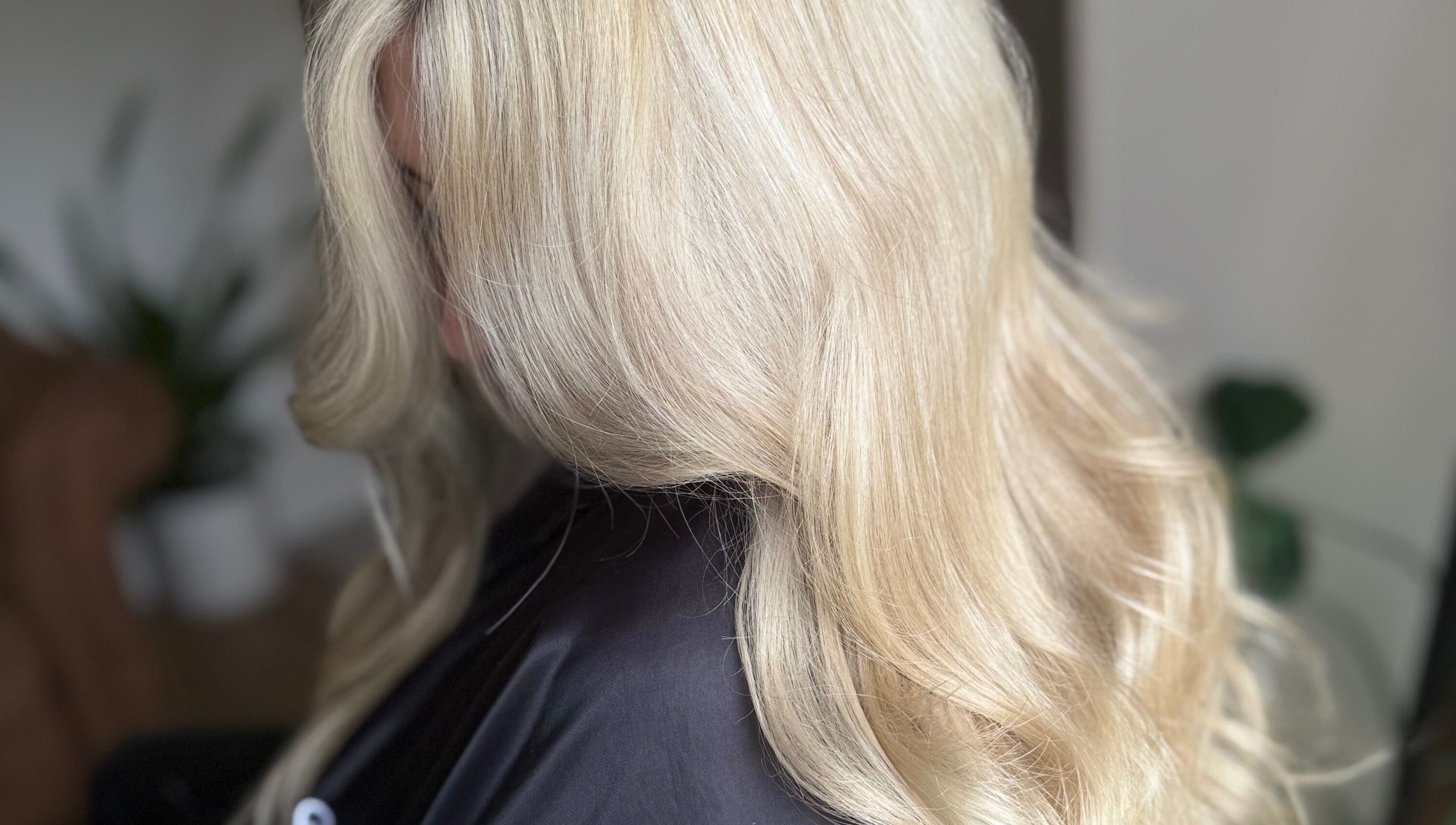 Elegant blonde hair styled in soft waves at Hairbypheebs, Nirimba, Queensland, AU.