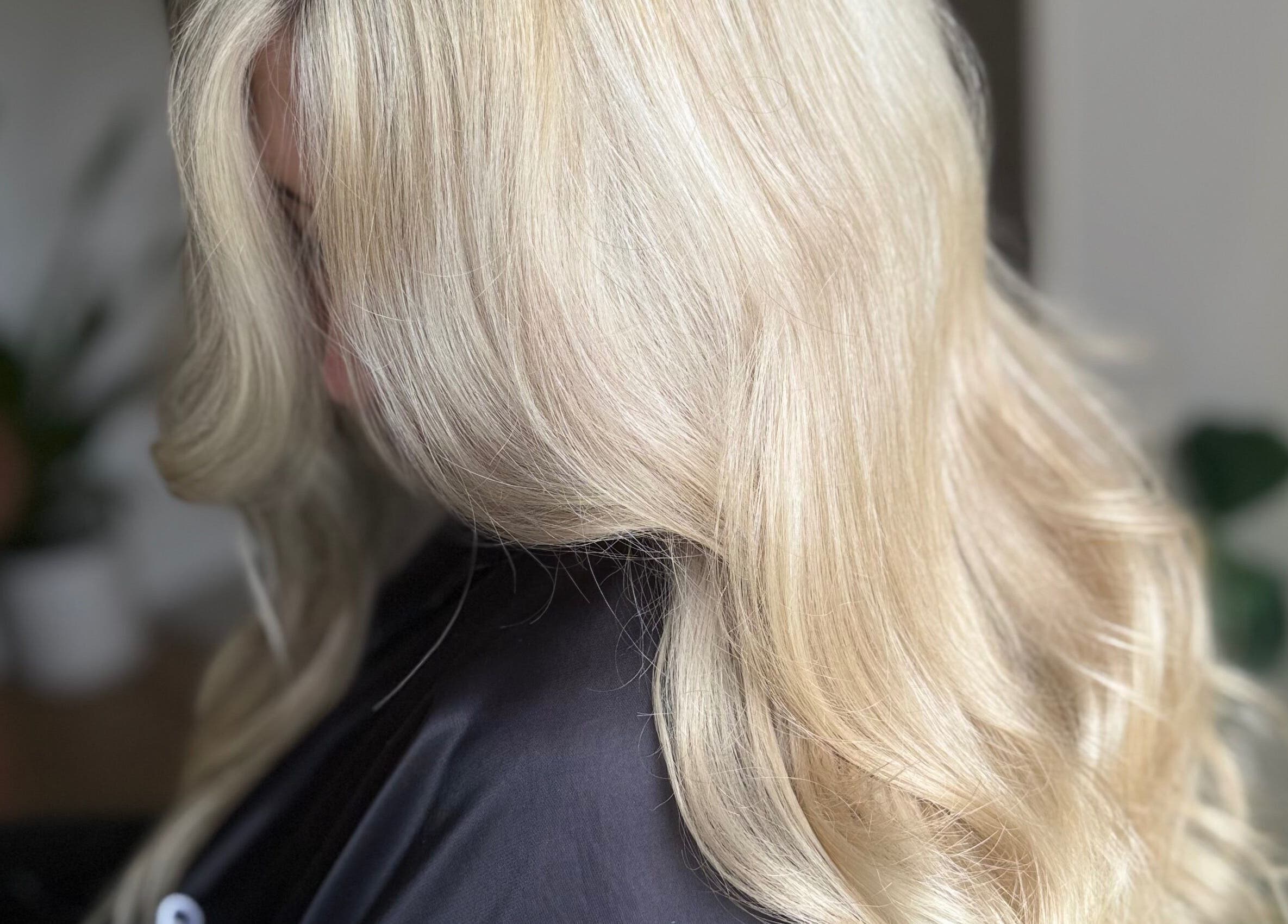 Elegant blonde hair styled in soft waves at Hairbypheebs, Nirimba, Queensland, AU.