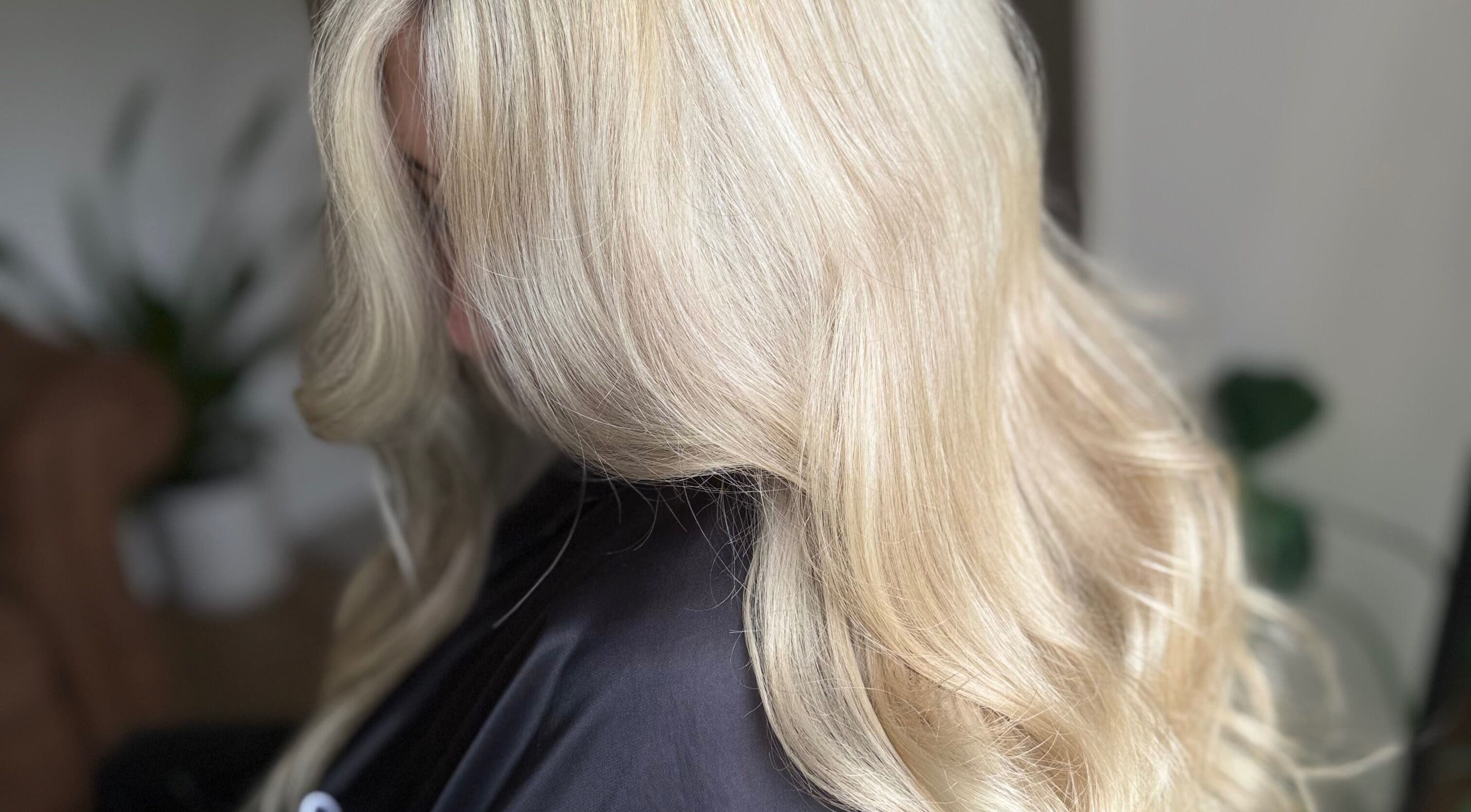 Elegant blonde hair styled in soft waves at Hairbypheebs, Nirimba, Queensland, AU.