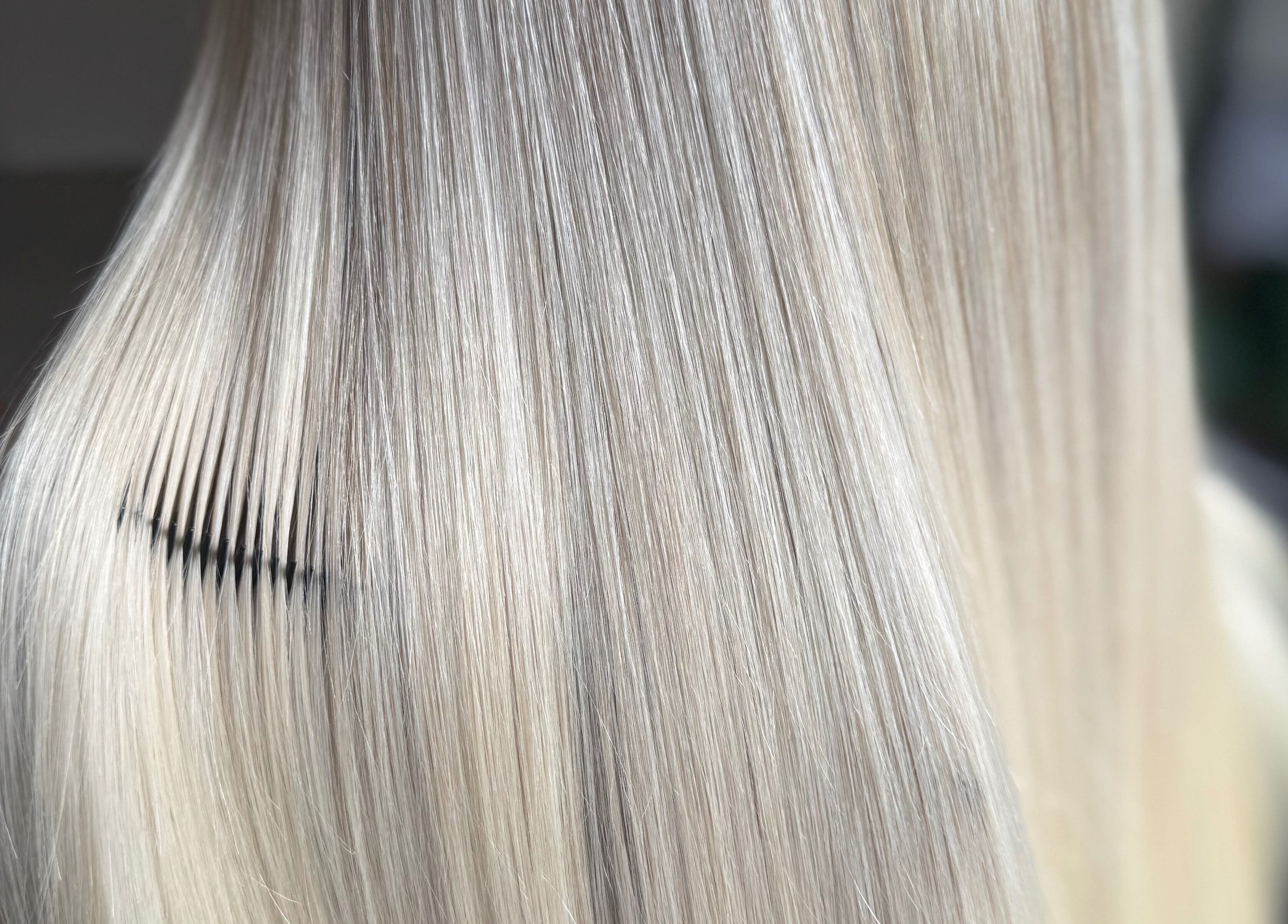 Sleek, straight blonde hair being combed at Hairbypheebs in Nirimba, Queensland, AU.