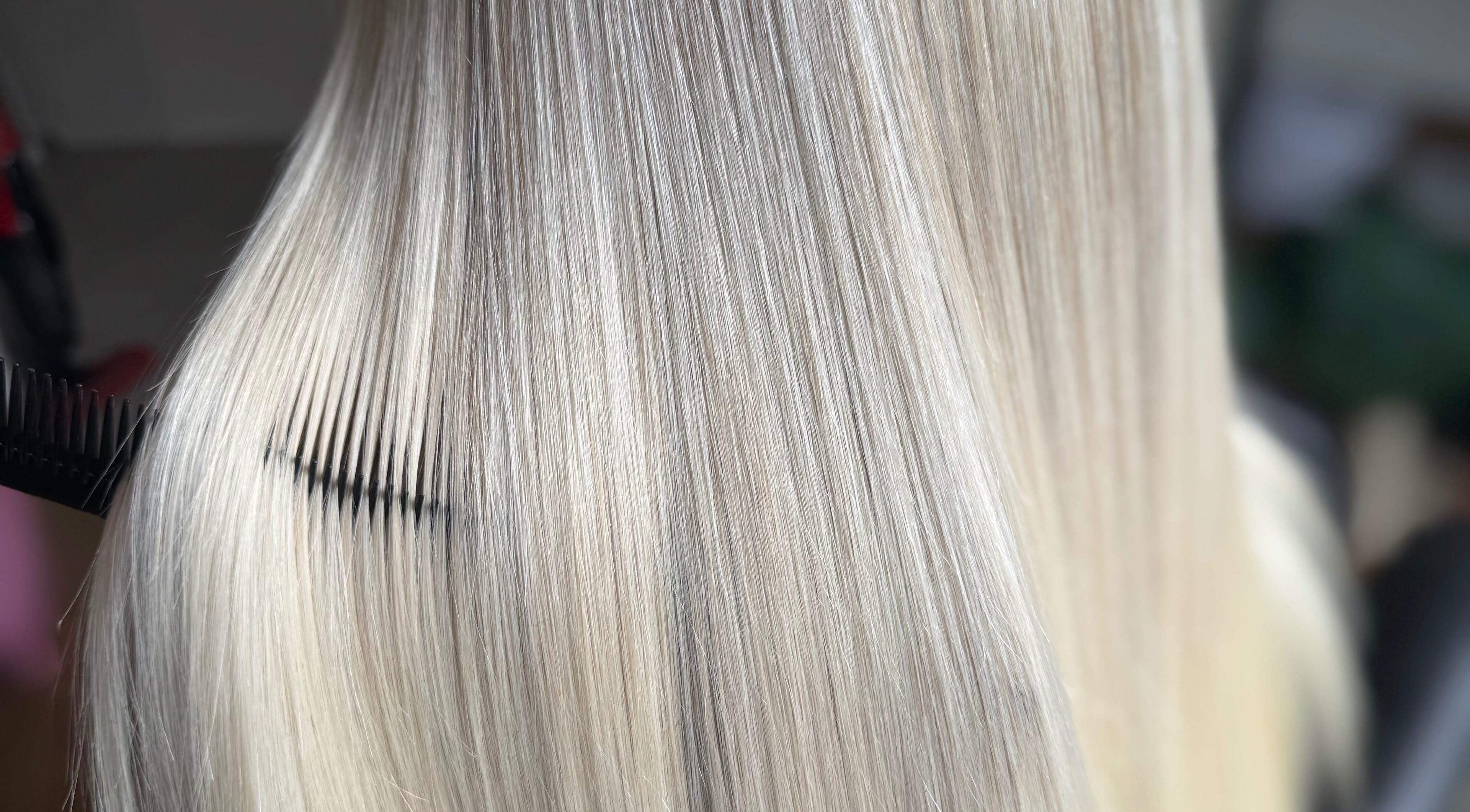 Sleek, straight blonde hair being combed at Hairbypheebs in Nirimba, Queensland, AU.