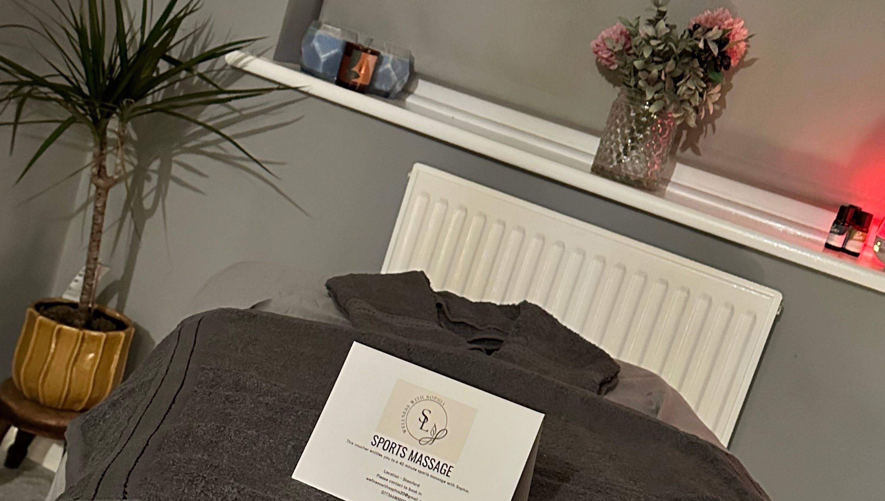 Cozy massage setup at Wellness With Sophia, Stamford, England with soft towels and calming decor.