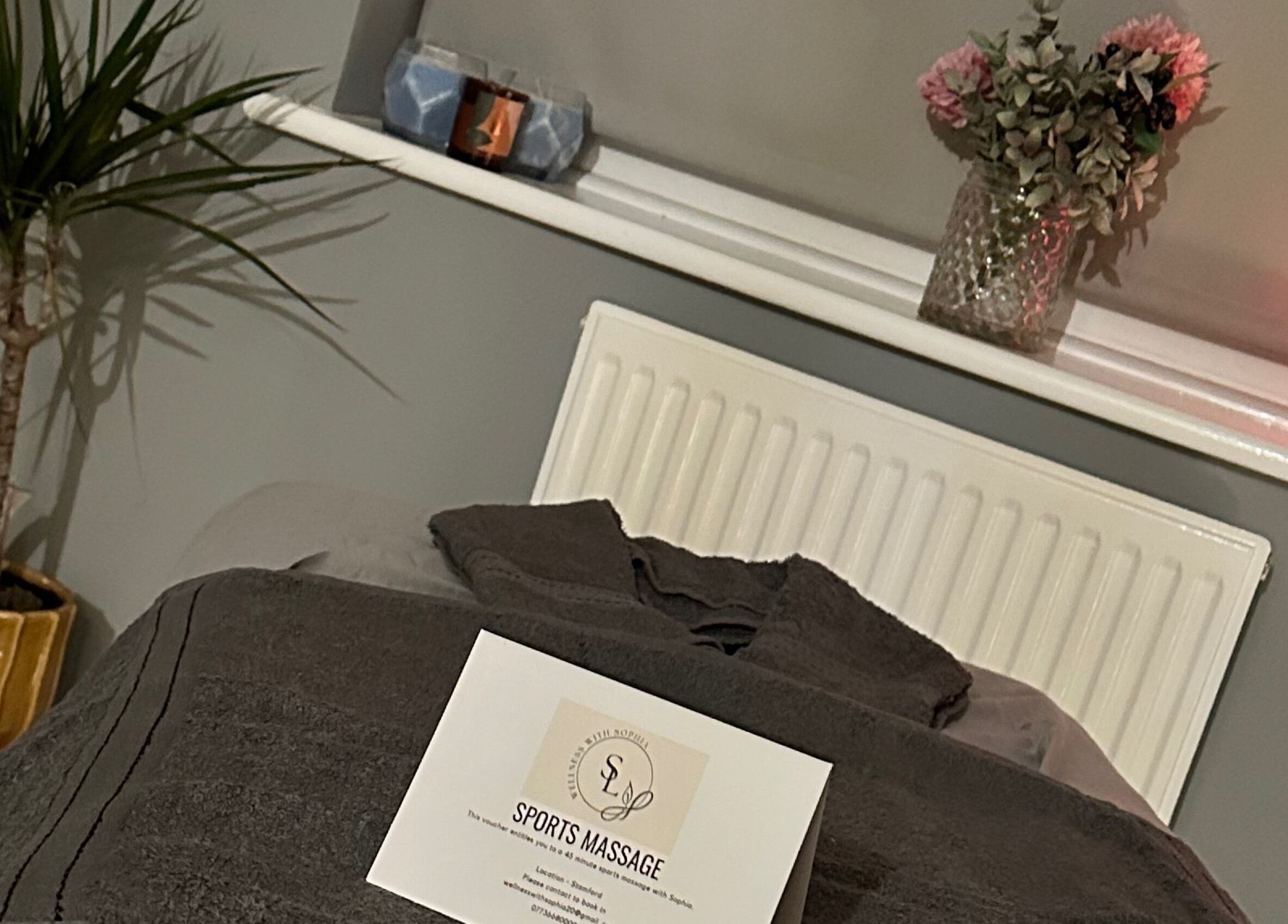 Cozy massage setup at Wellness With Sophia, Stamford, England with soft towels and calming decor.