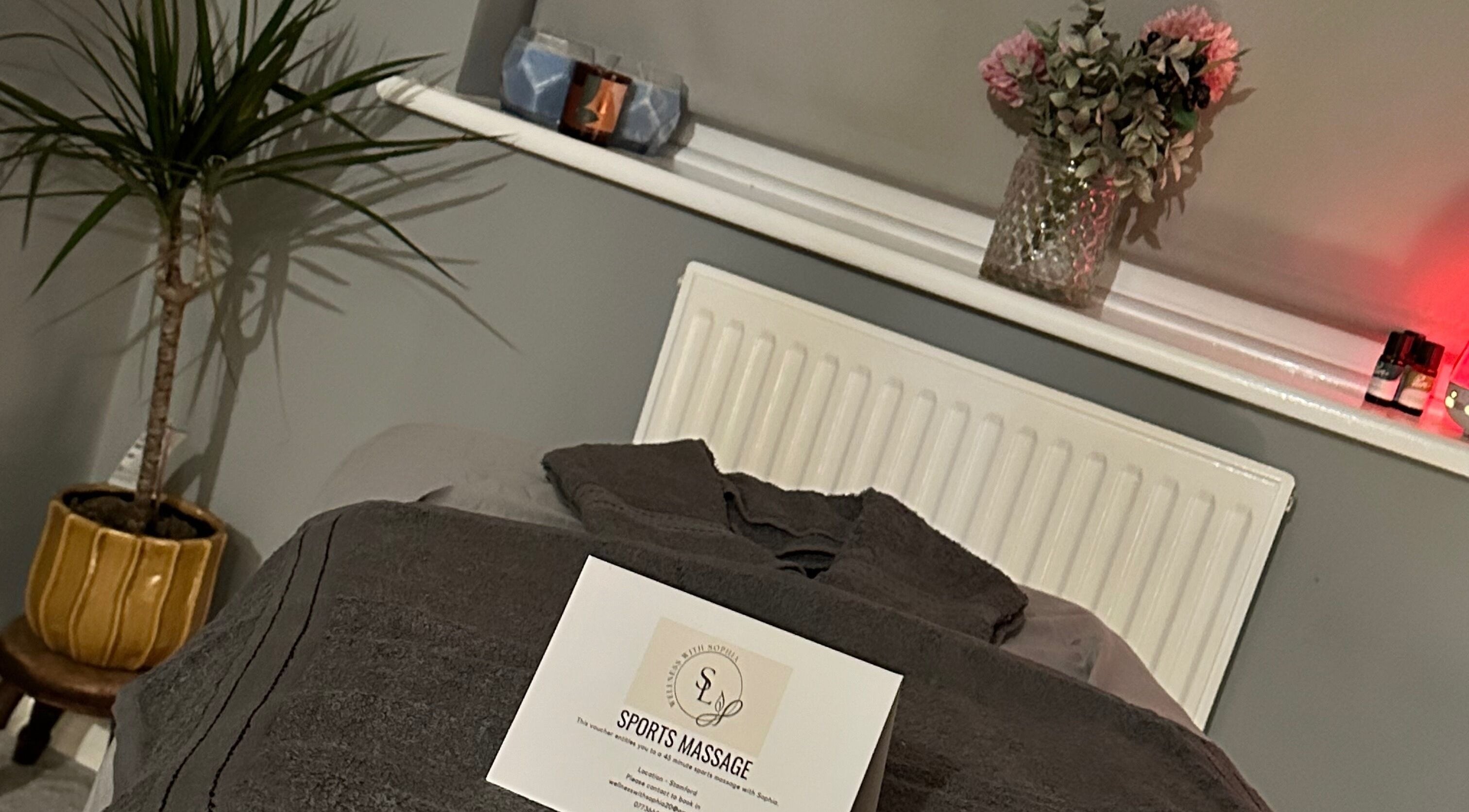 Cozy massage setup at Wellness With Sophia, Stamford, England with soft towels and calming decor.