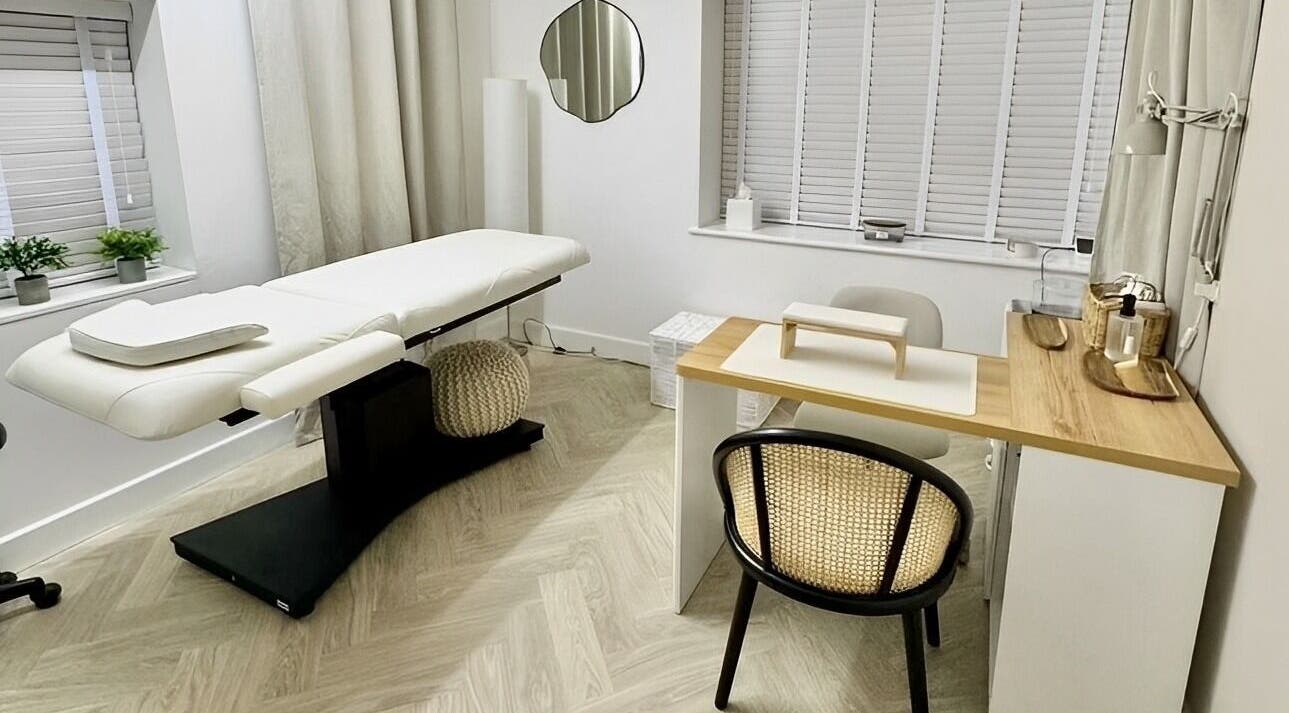 Cozy treatment room at The Lookery Beauty Room, Milton Keynes, England, GB, featuring a massage bed and nail station.