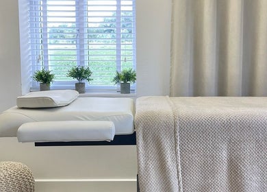 Tranquil treatment room at The Lookery Beauty Room, Milton Keynes, England, GB with lush greenery outside.