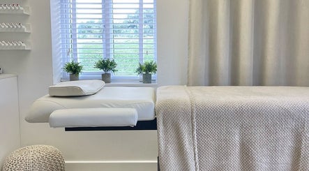 Tranquil treatment room at The Lookery Beauty Room, Milton Keynes, England, GB with lush greenery outside.