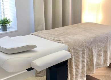 Tranquil therapy room at The Lookery Beauty Room, Milton Keynes, England, GB, featuring a comfortable massage bed.