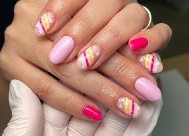Colorful nail art at The Lookery Beauty Room, Milton Keynes, England, GB showcasing pink and striped designs.