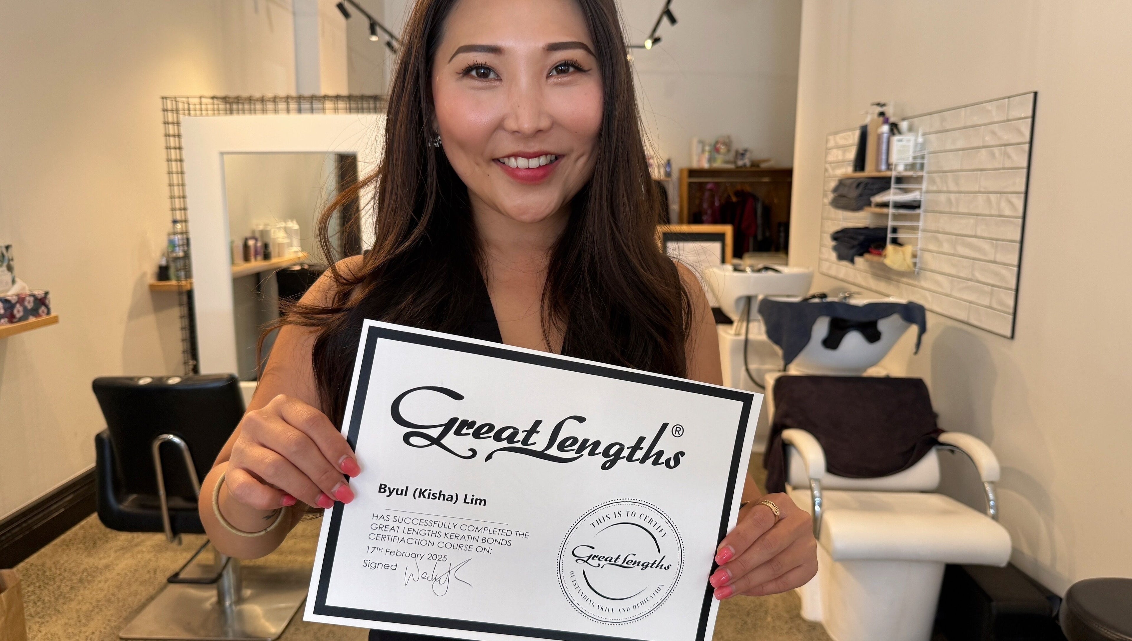 Kisha showcasing her Great Lengths certificate at Hair By Kisha, Hairsalon Faraday, Auckland, Auckland, NZ.