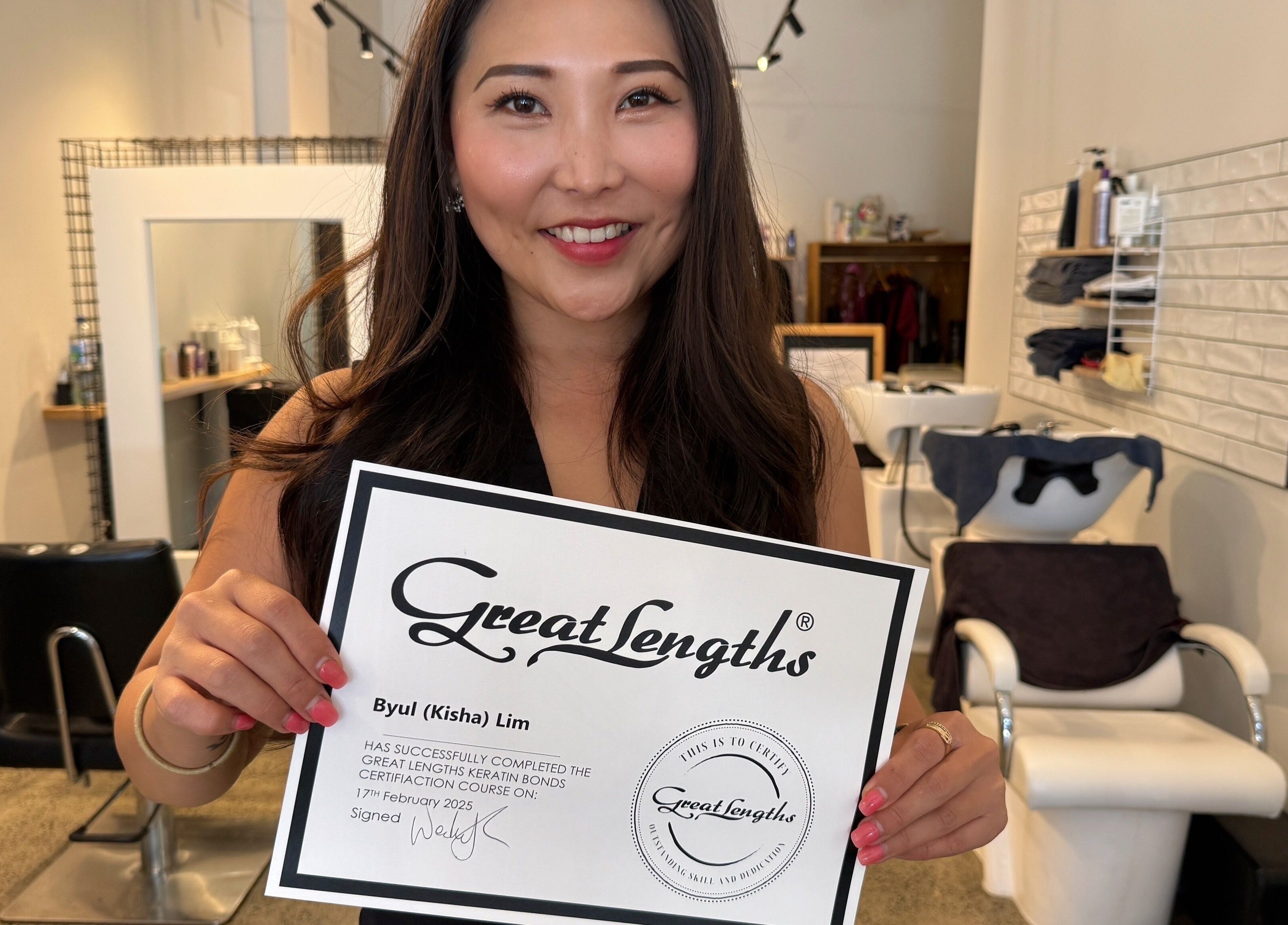 Kisha showcasing her Great Lengths certificate at Hair By Kisha, Hairsalon Faraday, Auckland, Auckland, NZ.
