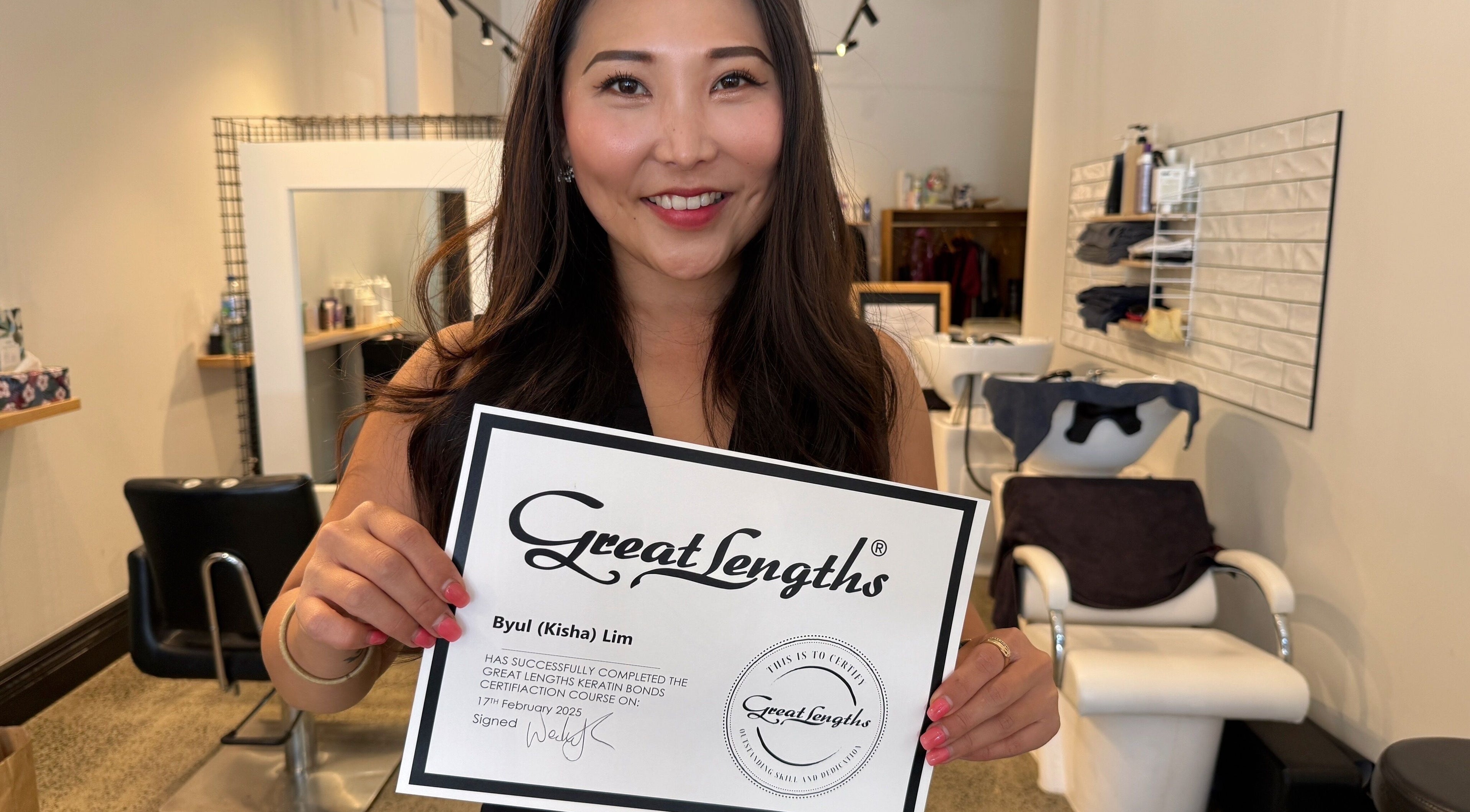 Kisha showcasing her Great Lengths certificate at Hair By Kisha, Hairsalon Faraday, Auckland, Auckland, NZ.