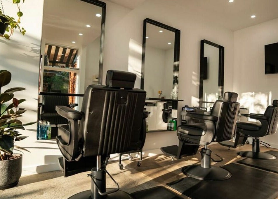 Modern barber chairs at Lost Boys Tugun in Tugun, Queensland, AU with bright natural lighting and plants.