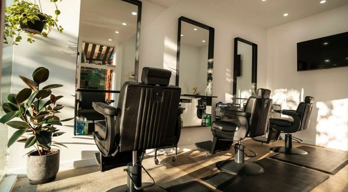 Modern barber chairs at Lost Boys Tugun in Tugun, Queensland, AU with bright natural lighting and plants.