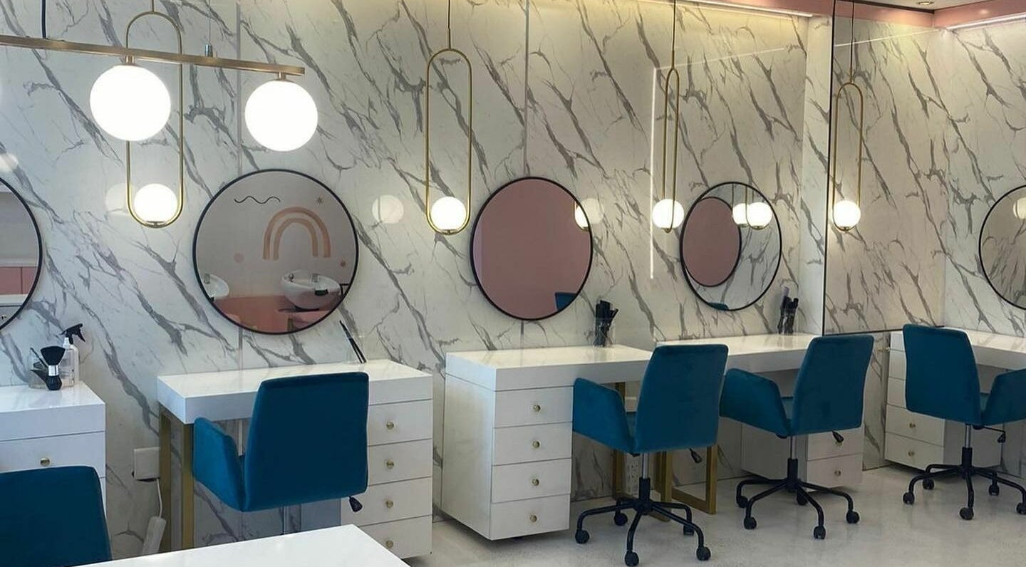 Elegant interior of Posh Angels Luxury Kids Salon in Sandton, Gauteng, ZA featuring chic styling stations.