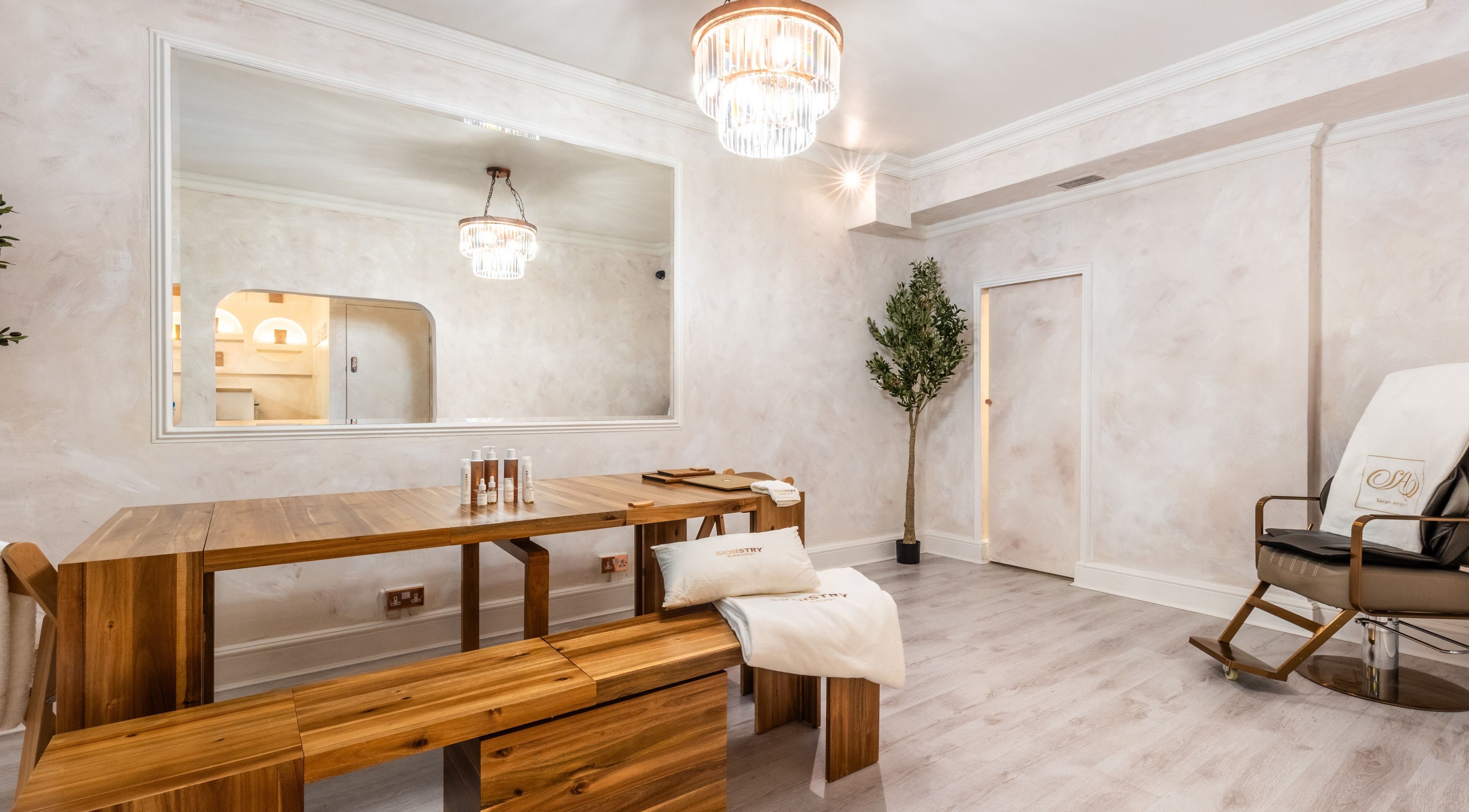 Sarah Artistry Clinic's elegant treatment room with wooden decor in London, England, GB.