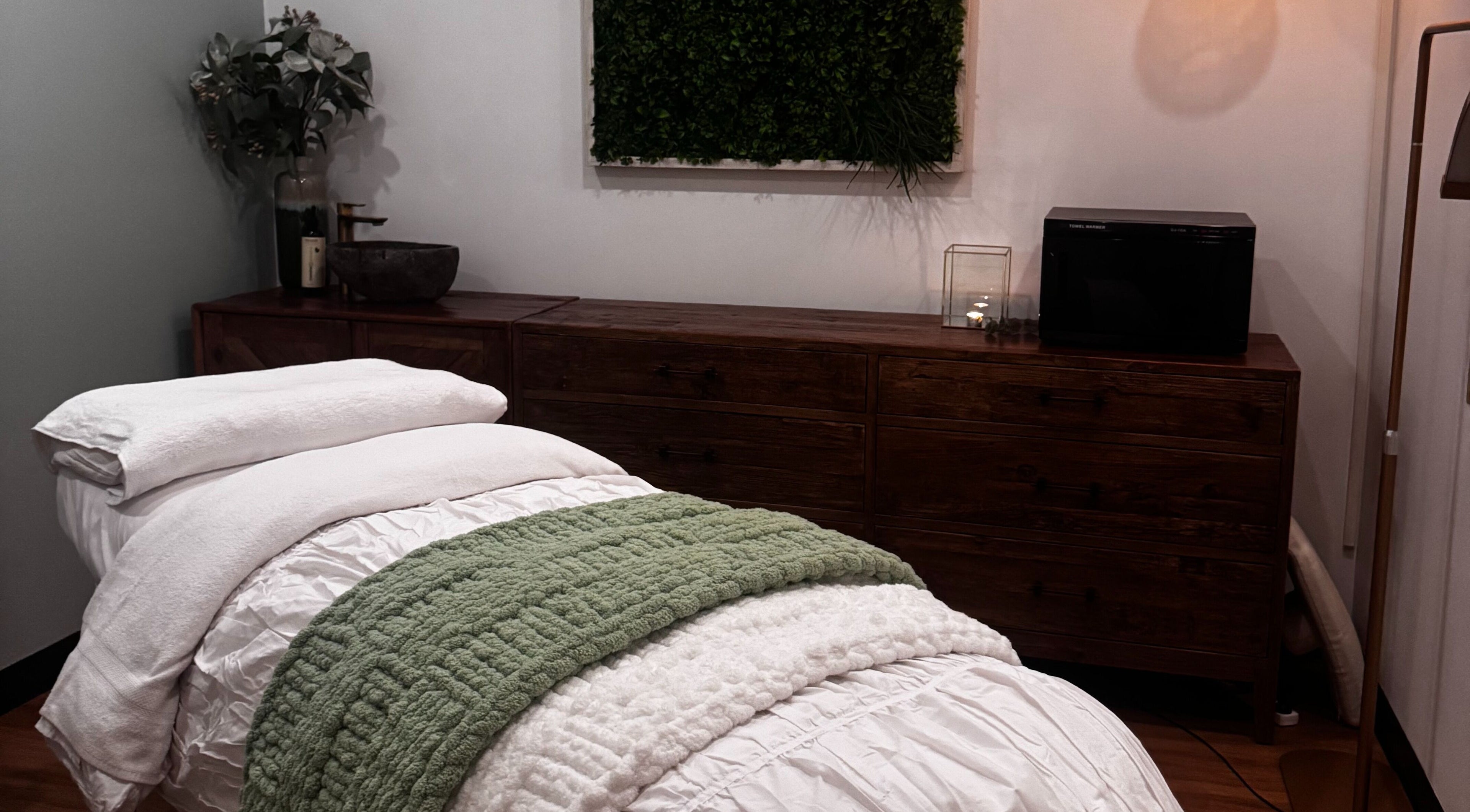 Cozy massage room at Soul Beauty Co, Edge Hill, Queensland, AU, featuring plush bedding and soothing decor.
