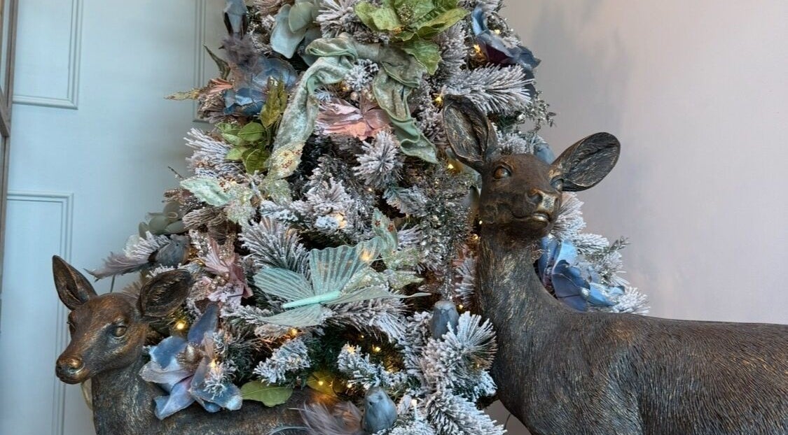 Festive deer statues beside a decorated tree at Soul Beauty Co, Edge Hill, Queensland, AU.