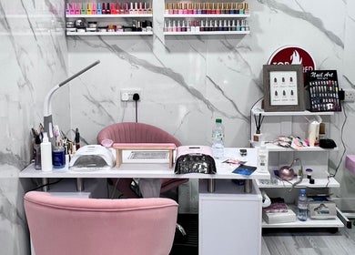 Modern nail station at Star Nail Riddrie in Glasgow, Scotland, GB, featuring elegant pink decor and nail polish display.