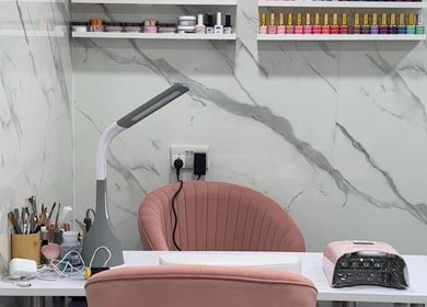 Modern nail station at Star Nail Riddrie, Glasgow, Scotland, GB, featuring sleek design and variety of nail colors.
