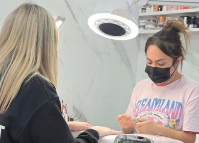 Nail technician works on client's nails at Star Nail Riddrie, Glasgow, Scotland, GB.