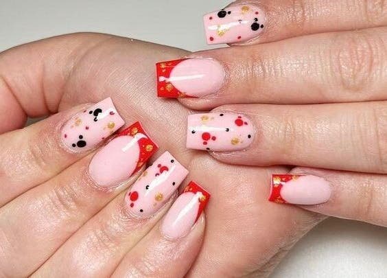 Bright nail art with red tips and confetti at Star Nail & Beauty Riddrie, Glasgow, Scotland, GB.