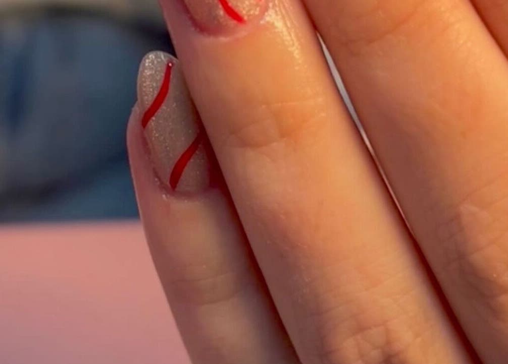 Elegant glitter nail design with red spirals at Star Nail & Beauty Riddrie, Glasgow, Scotland, GB.