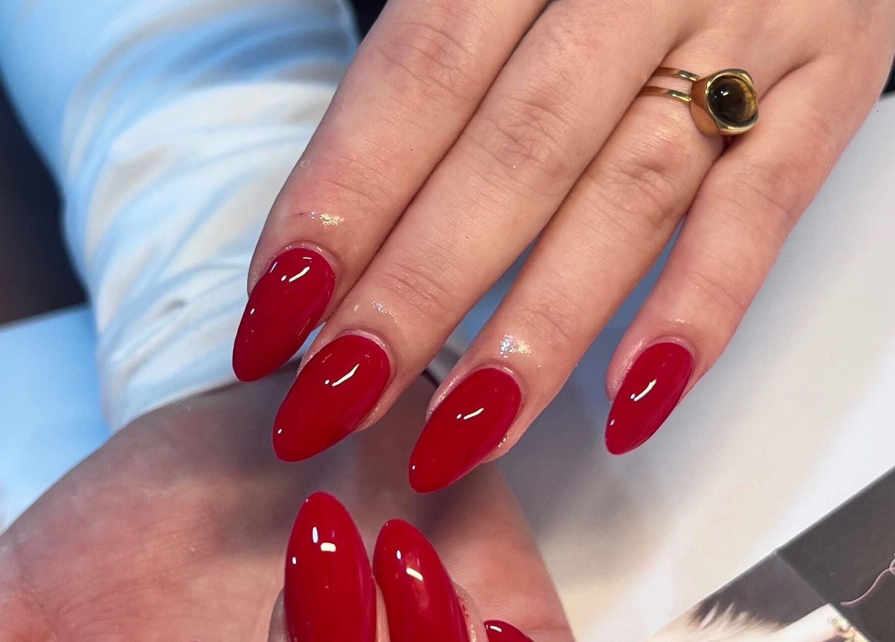 Red manicured nails at Star Nail & Beauty Riddrie in Glasgow, Scotland, GB. Chic and glossy finish.