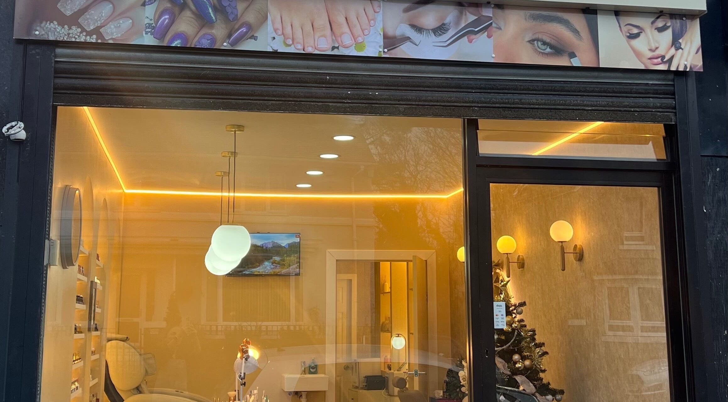 Front view of Star Nail & Beauty Riddrie, Glasgow, Scotland, GB, showing elegant interior lighting and decor.