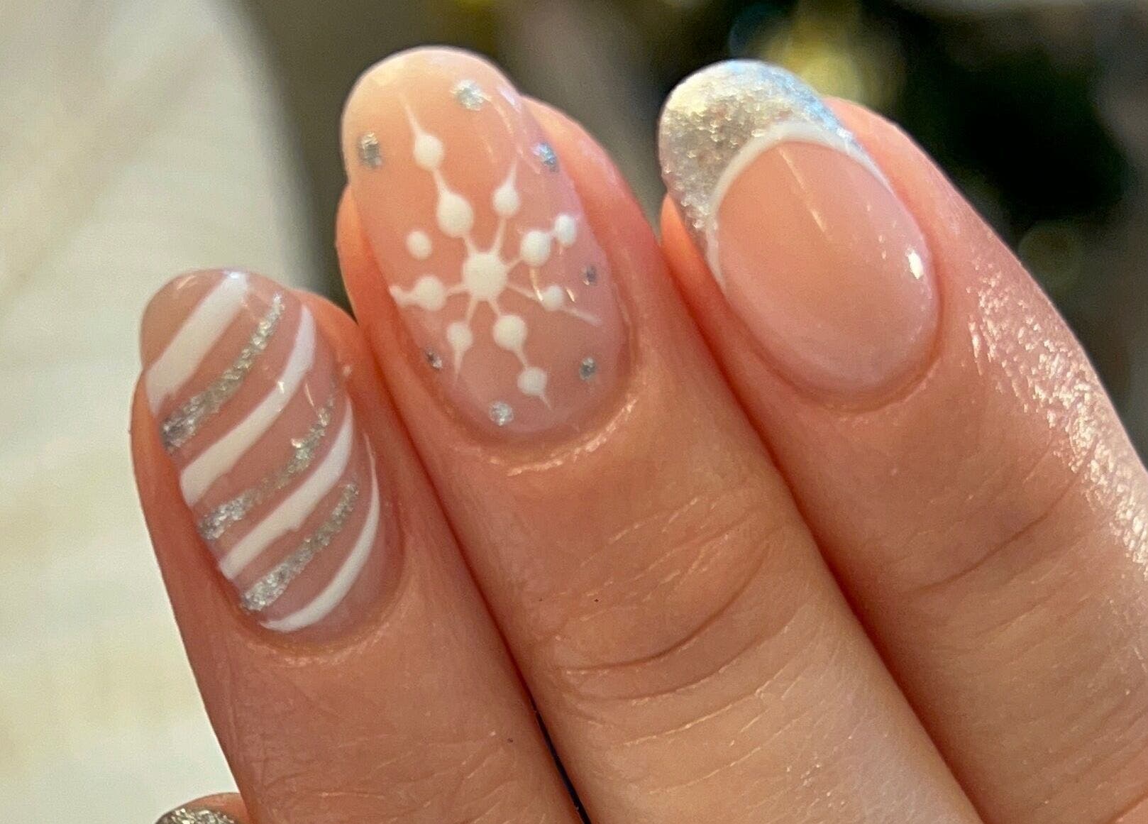 Festive nail art at Star Nail & Beauty Riddrie, Glasgow, Scotland, GB, featuring snowflakes and silver glitter.