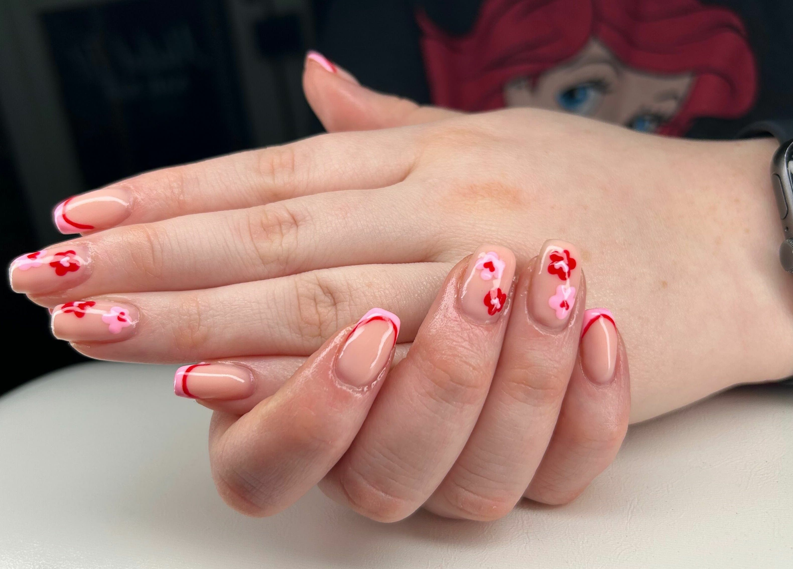 Elegant floral nail art at Nailed it! Sauchie, Scotland, GB, showcasing intricate red and pink designs.