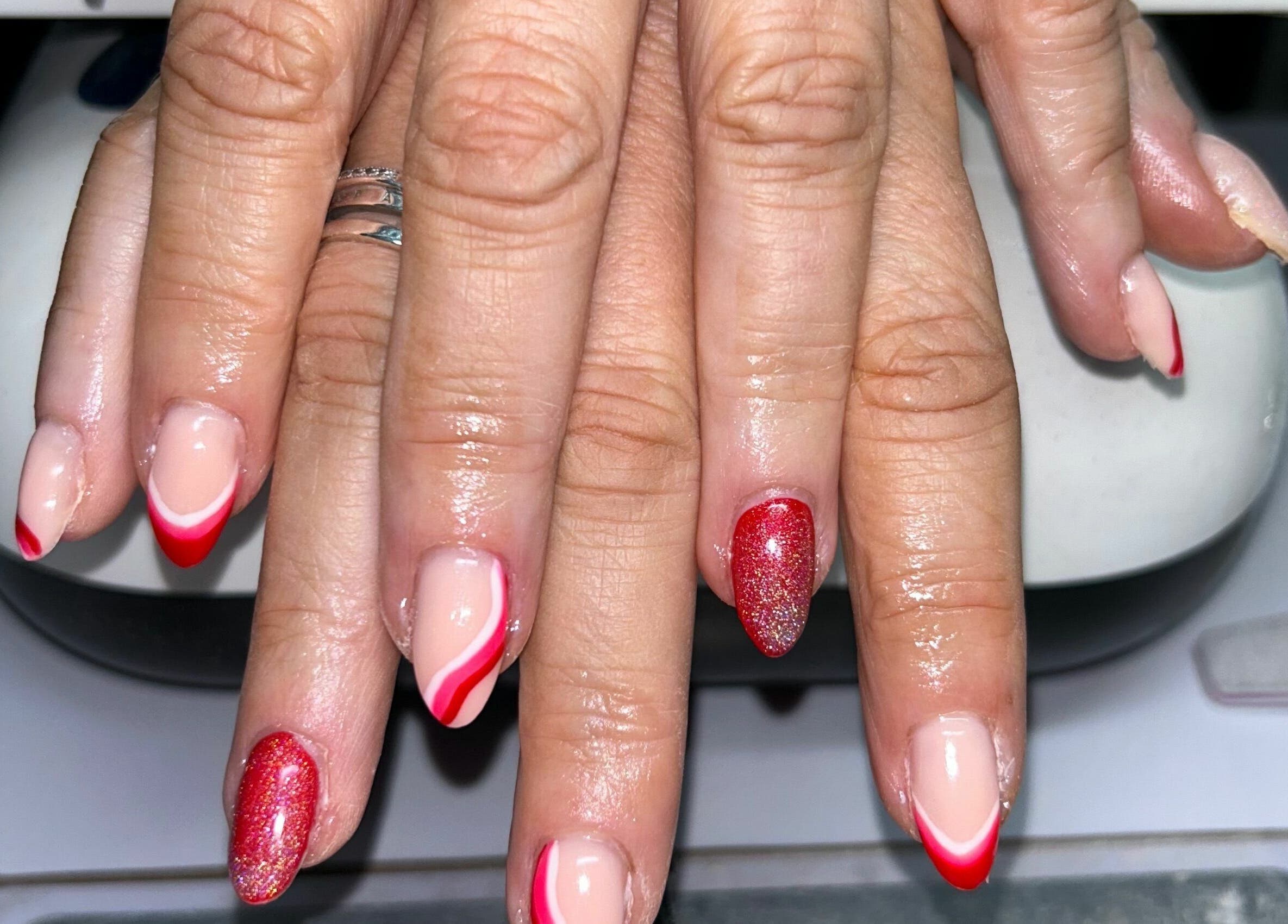 Elegant red gradient manicure at Nailed It! in Sauchie, Scotland, GB. Perfect for a stylish look.