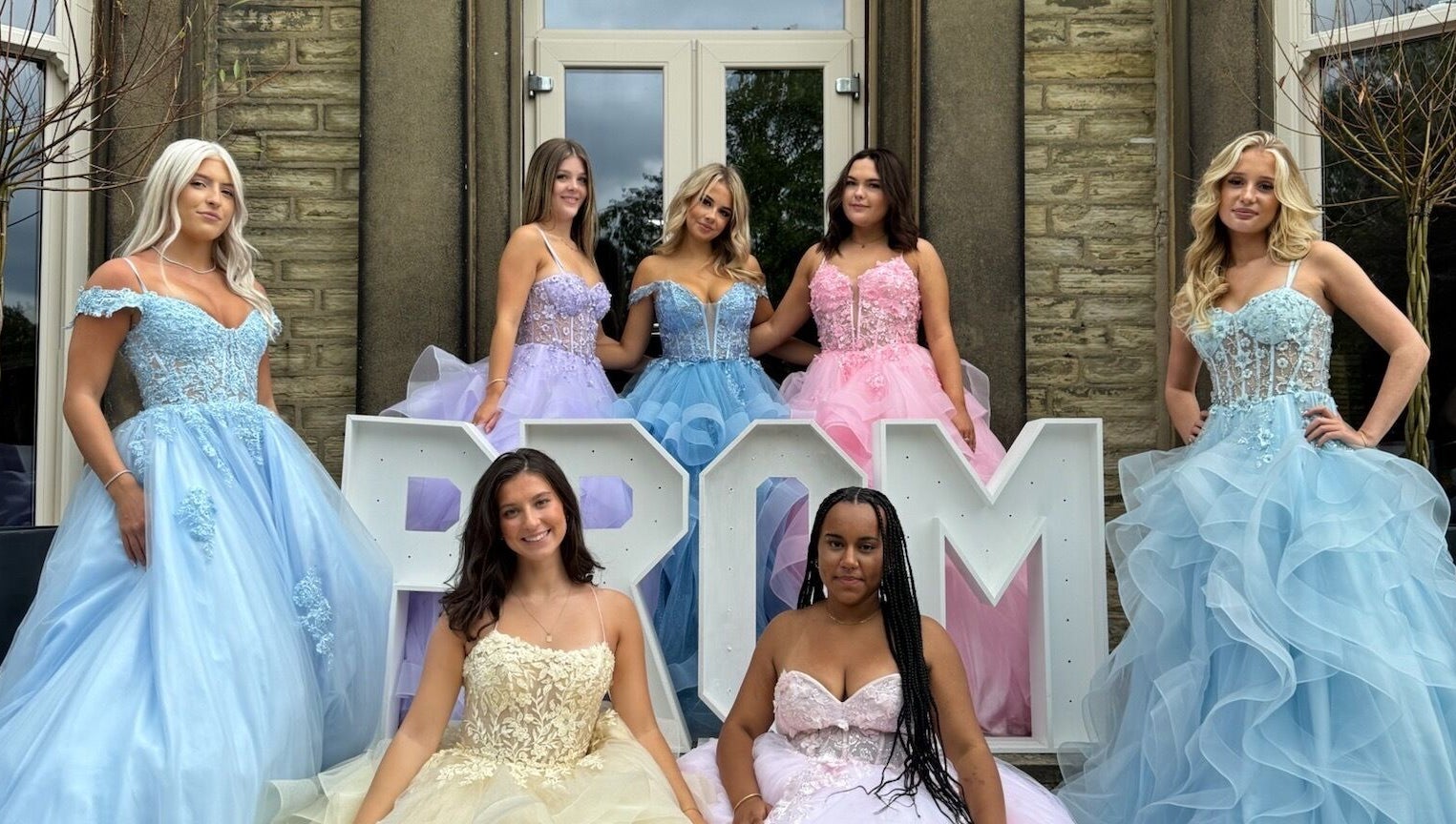 Prom dresses showcased at The Prom Den - Horsforth, Horsforth, England, GB, in front of venue entrance.
