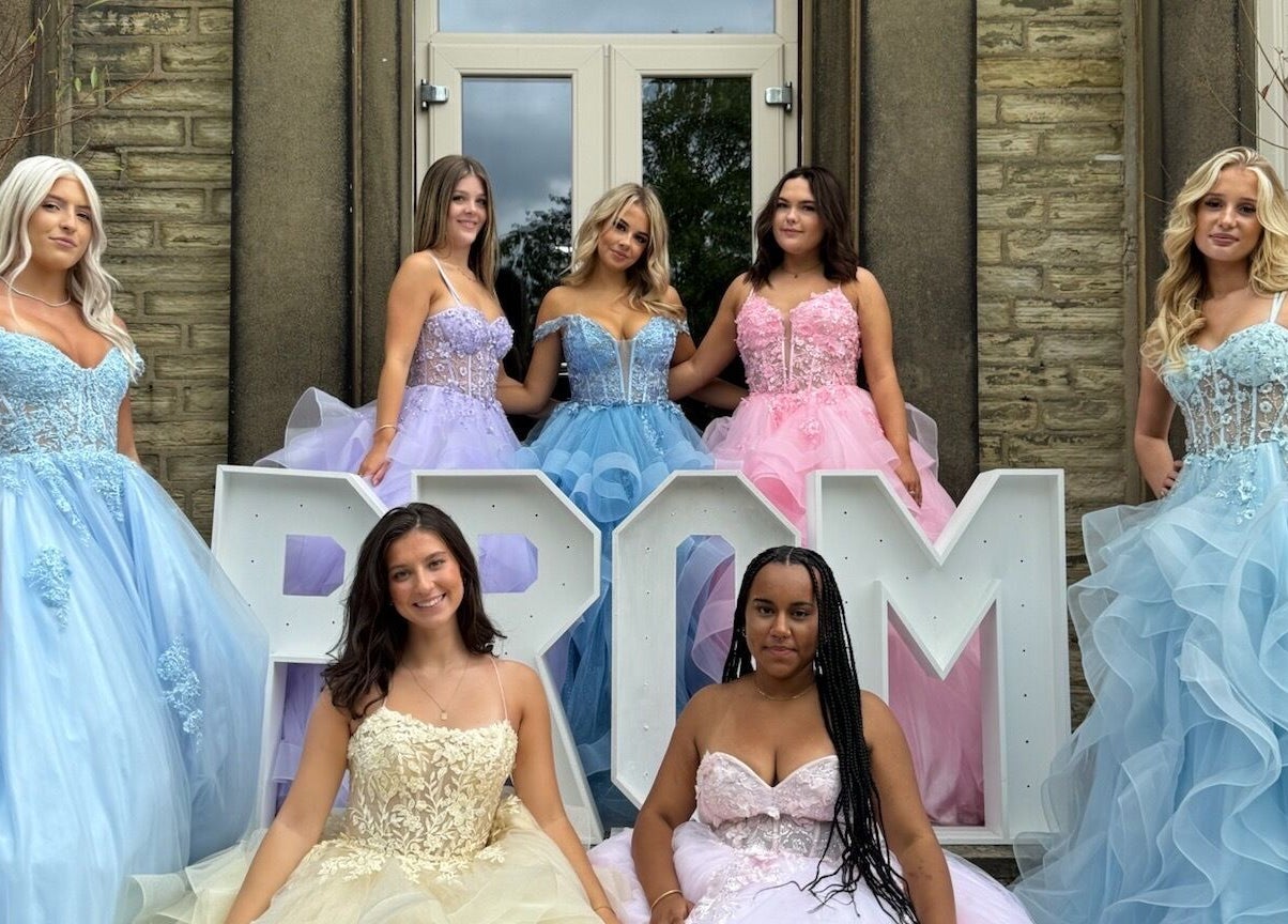 Prom dresses showcased at The Prom Den - Horsforth, Horsforth, England, GB, in front of venue entrance.