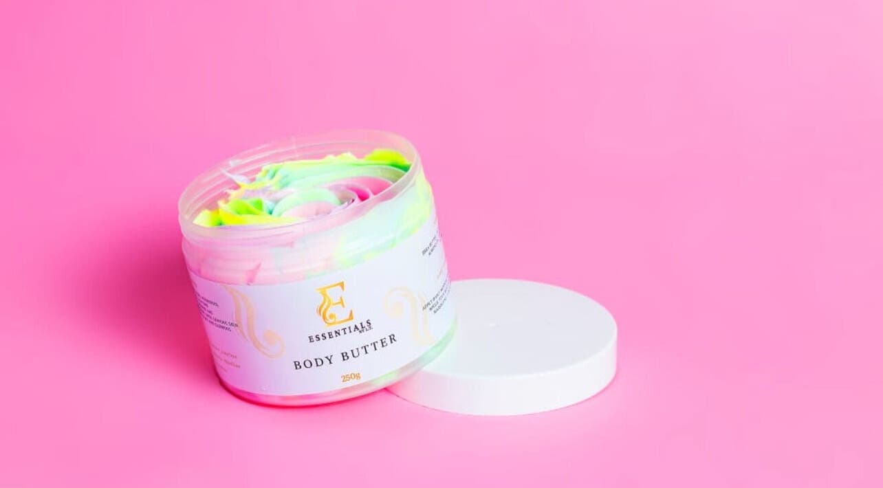 Vibrant body butter by Essentials by L.T in Midrand, Gauteng, ZA against a pink background.
