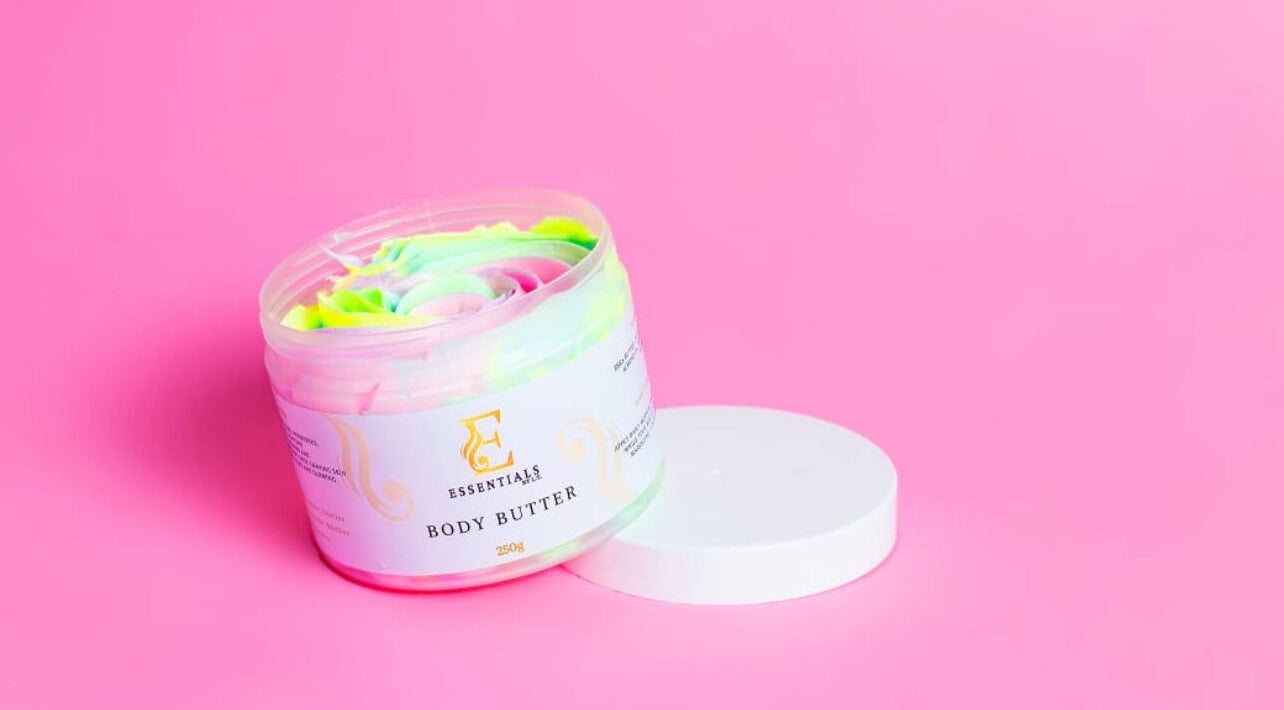Vibrant body butter by Essentials by L.T in Midrand, Gauteng, ZA against a pink background.