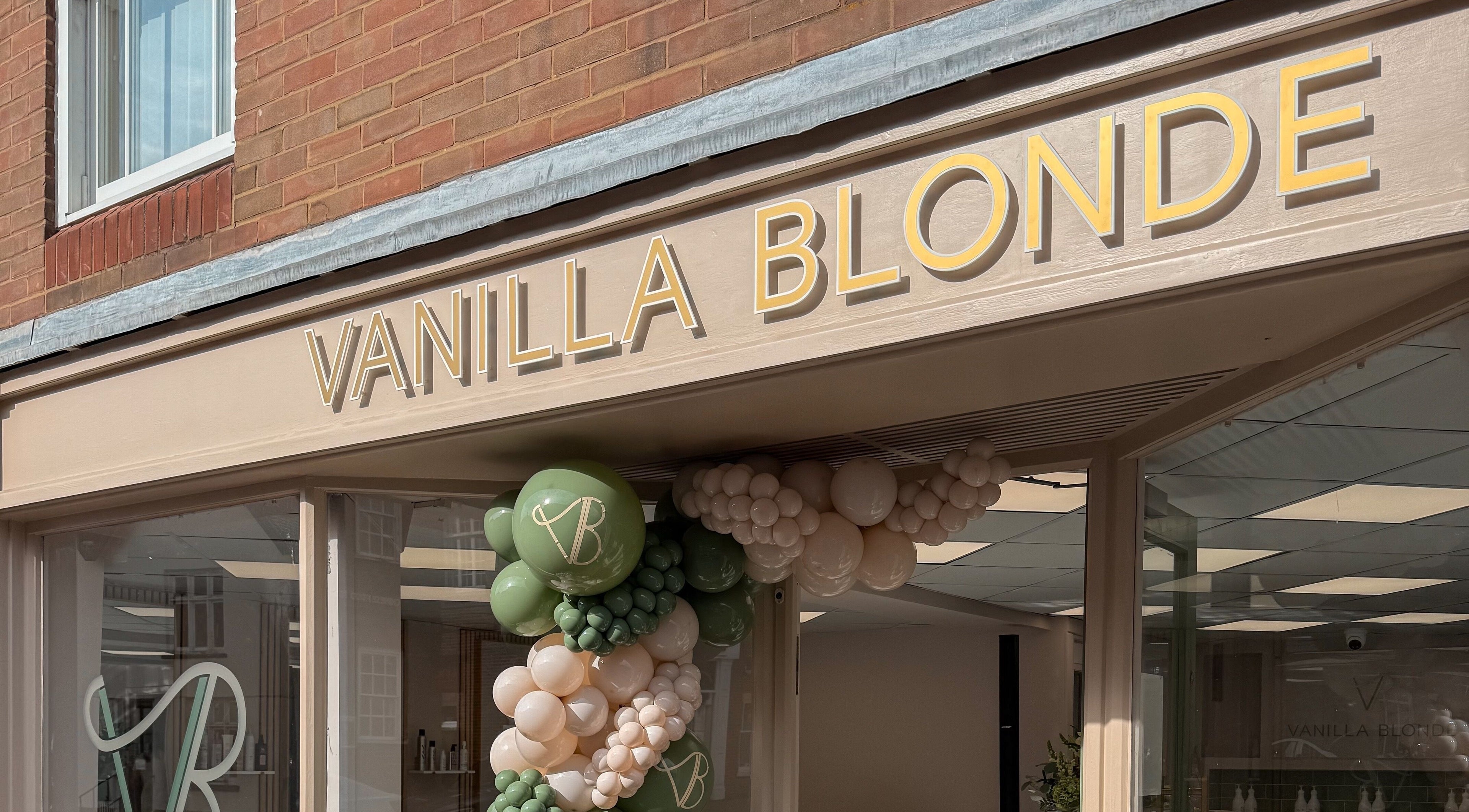 Entrance of Vanilla Blonde in Witham, England, GB, featuring stylish signage and decorative balloons.