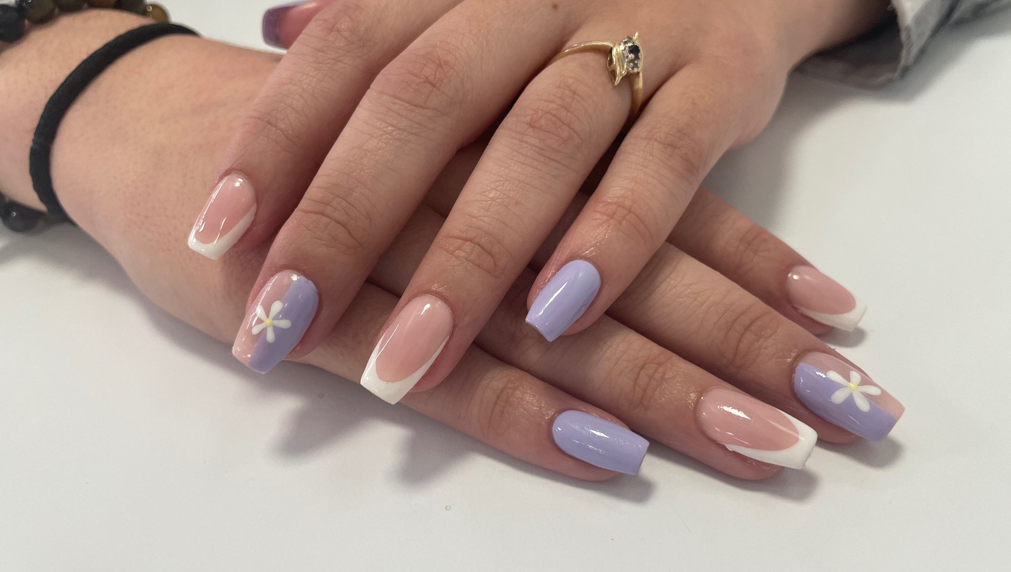 Elegant floral pastel nails at Jeweled by Jules, Ottawa, Ontario, CA. Perfectly manicured hands display nail designs.