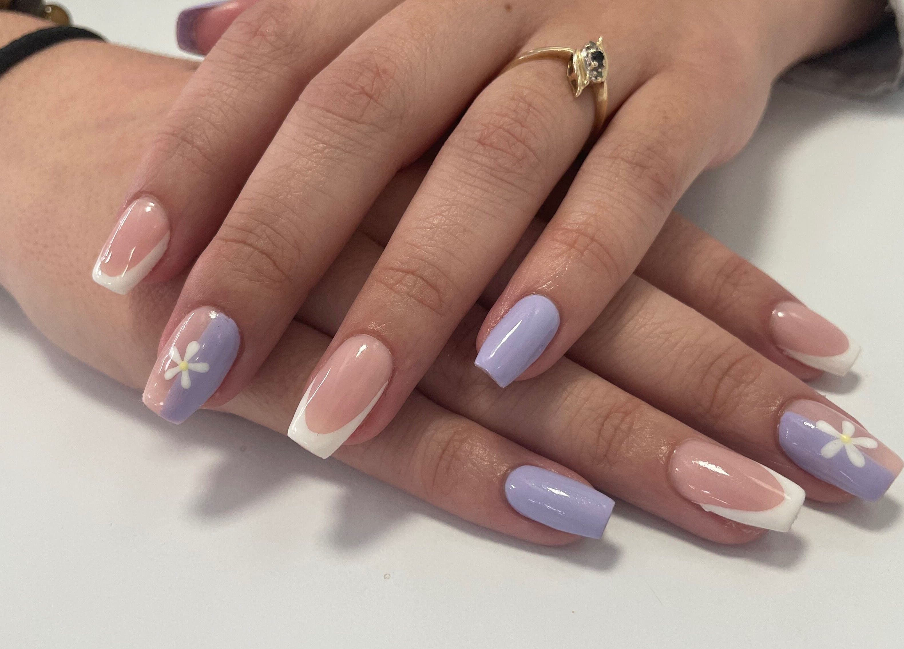 Elegant floral pastel nails at Jeweled by Jules, Ottawa, Ontario, CA. Perfectly manicured hands display nail designs.