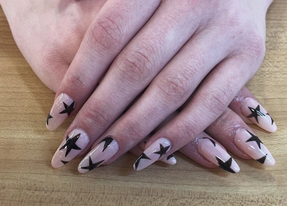 Star-themed nail art at Jeweled by Jules, Ottawa, Ontario, CA, highlights creative manicure design.
