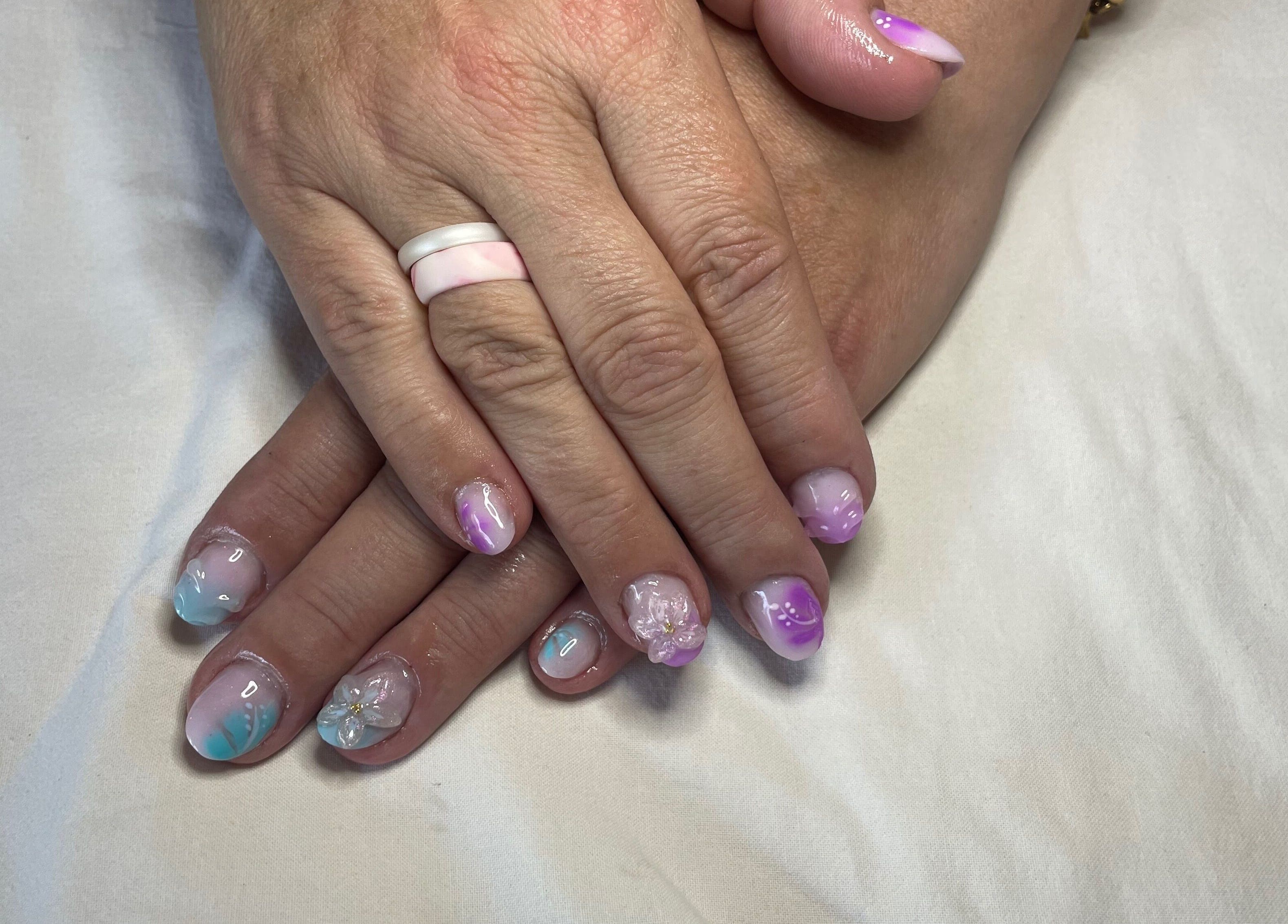 Beautiful pastel nail art at Jeweled by Jules in Ottawa, Ontario, CA showcases delicate flower designs.