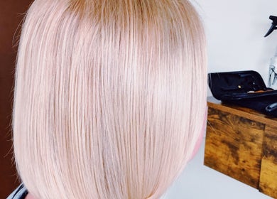 Shiny blonde hair at Southern Siren Studio in Jacksonville, Florida, US, styled in a sleek bob cut.