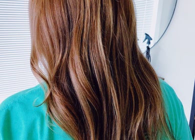Styled brunette hair at Southern Siren Studio, Jacksonville, Florida, US. Elegantly highlighted strands.